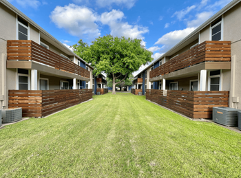 Apartment courtyard with green lawn and balconies